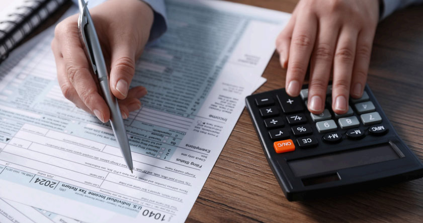 cta122 person using calculator and writing